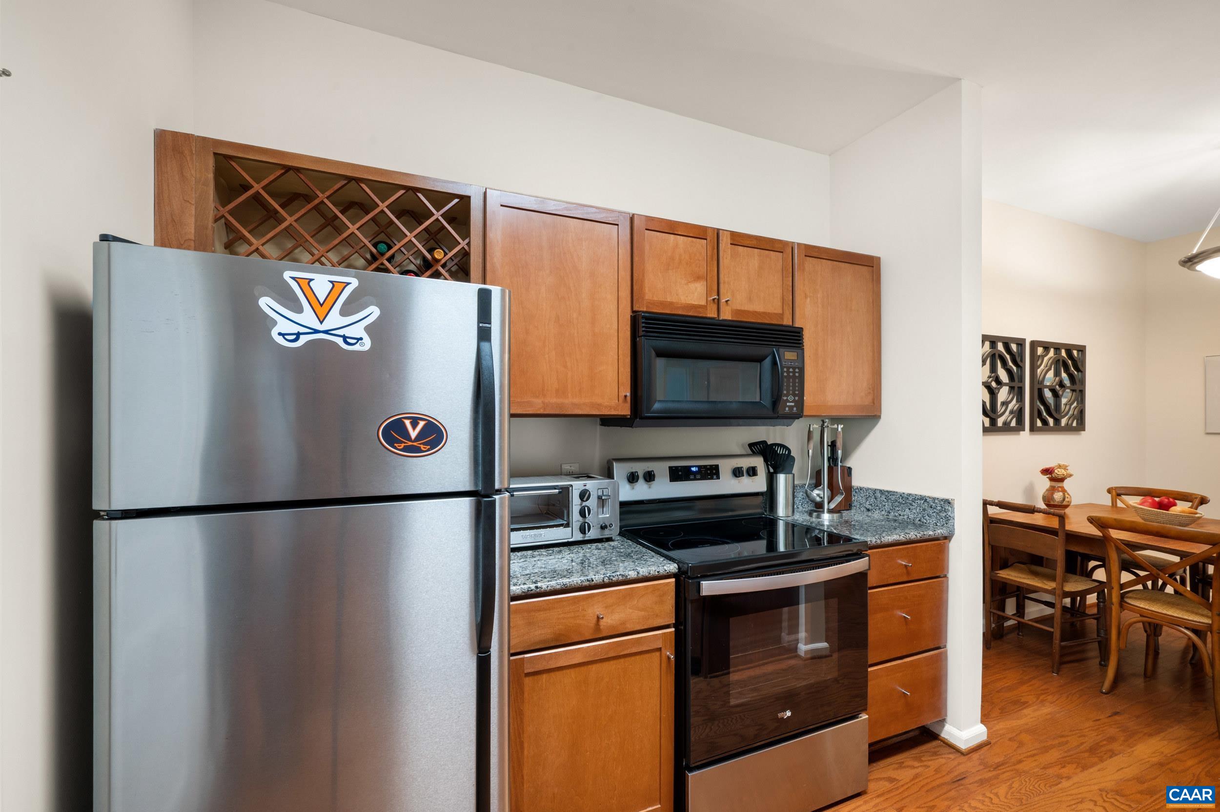 765 Walker Square, Unit 2D Charlottesville, VA 22903 - Photo 9 of 33 a kitchen with stainless steel appliances granite countertop a refrigerator and a stove top oven