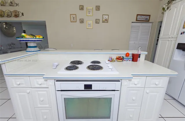 a kitchen with cabinets and window