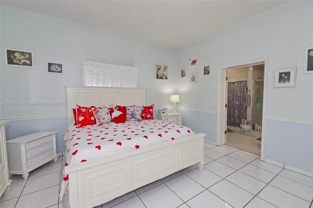 a bedroom with a bed and flat screen tv