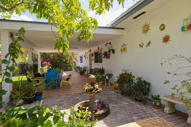 a flower garden is sitting in front of a house