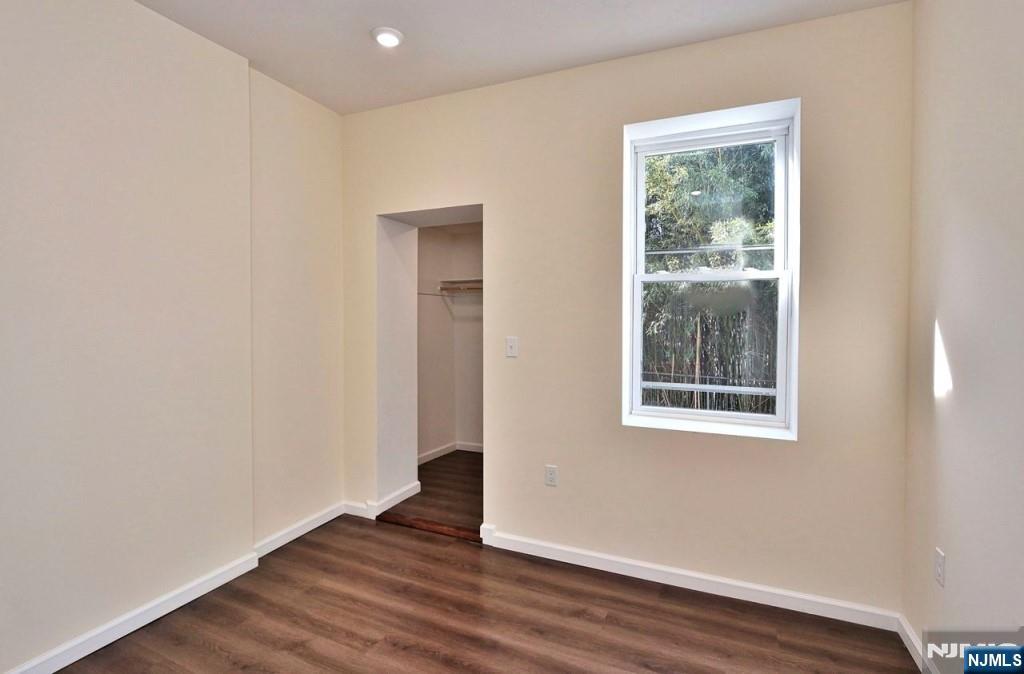 183 Bergen Turnpike Ridgefield Park, NJ 07660 - Photo 5 of 6 an empty room with wooden floor and windows