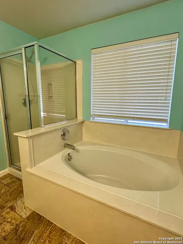 a bathroom with a bathtub and a shower