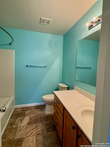 a bathroom with a sink a toilet and a mirror