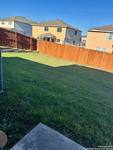 a view of yard with swimming pool outdoor seating and barbeque oven