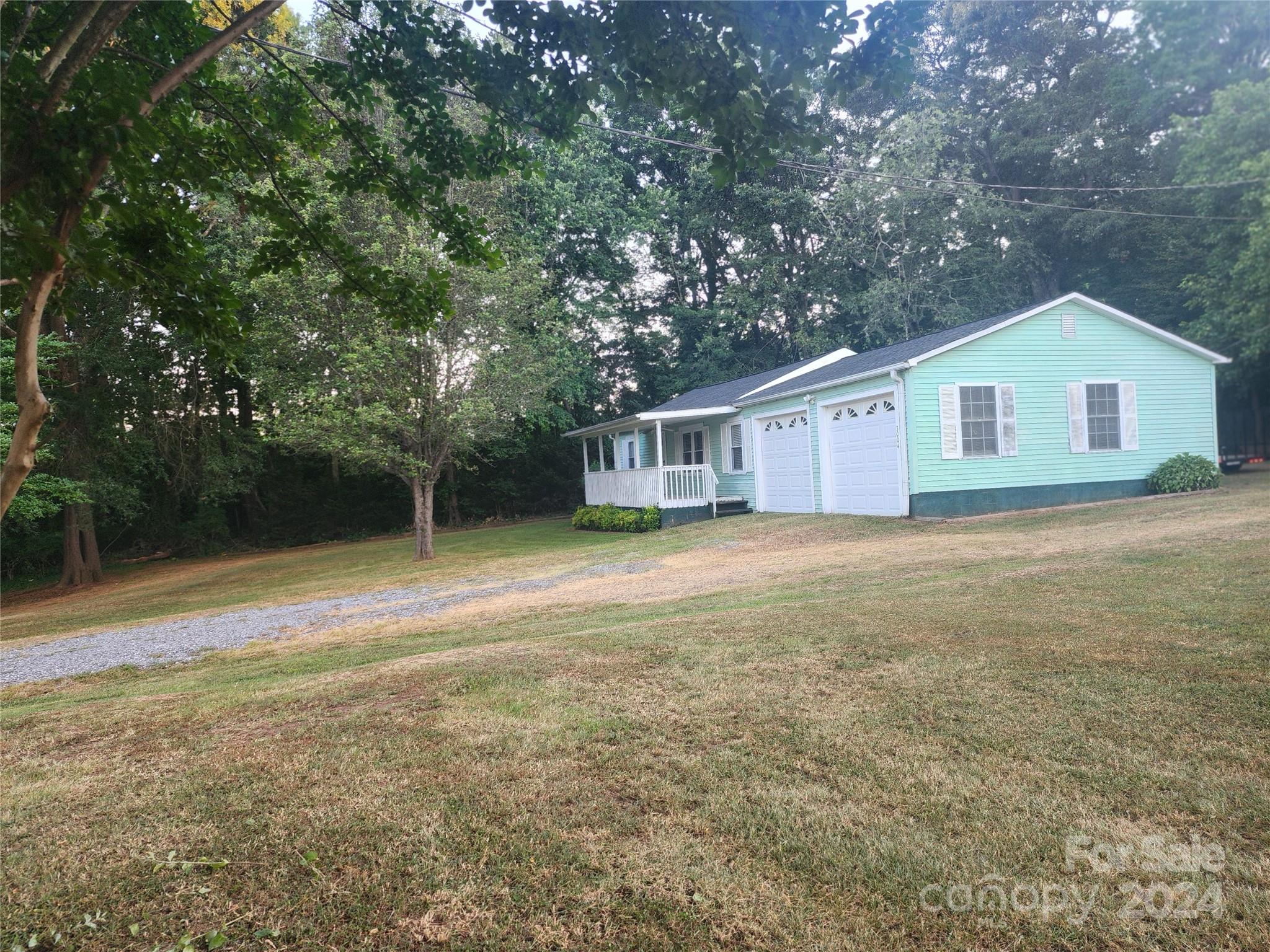 3004 Goble Road Hiddenite, NC 28636 - Photo 1 of 17 a view of a house with backyard and garden