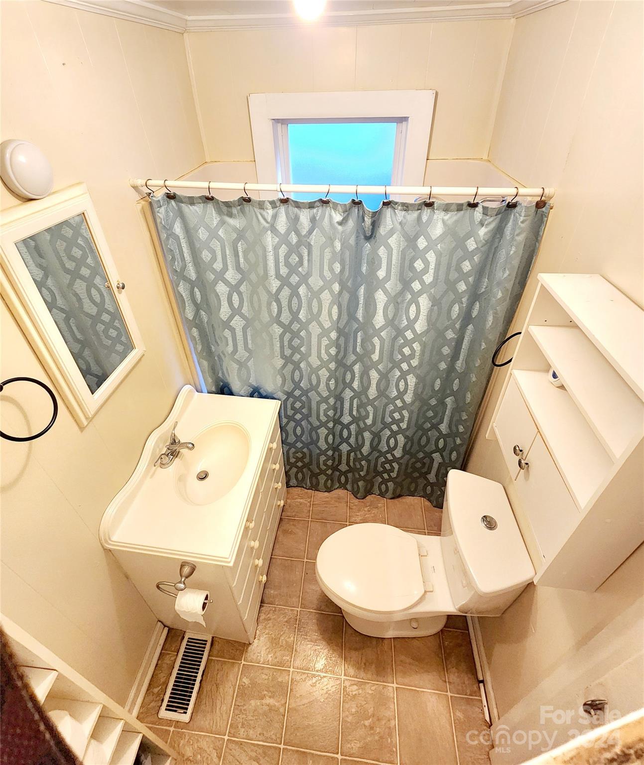 3004 Goble Road Hiddenite, NC 28636 - Photo 8 of 17 a bathroom with a toilet sink and mirror