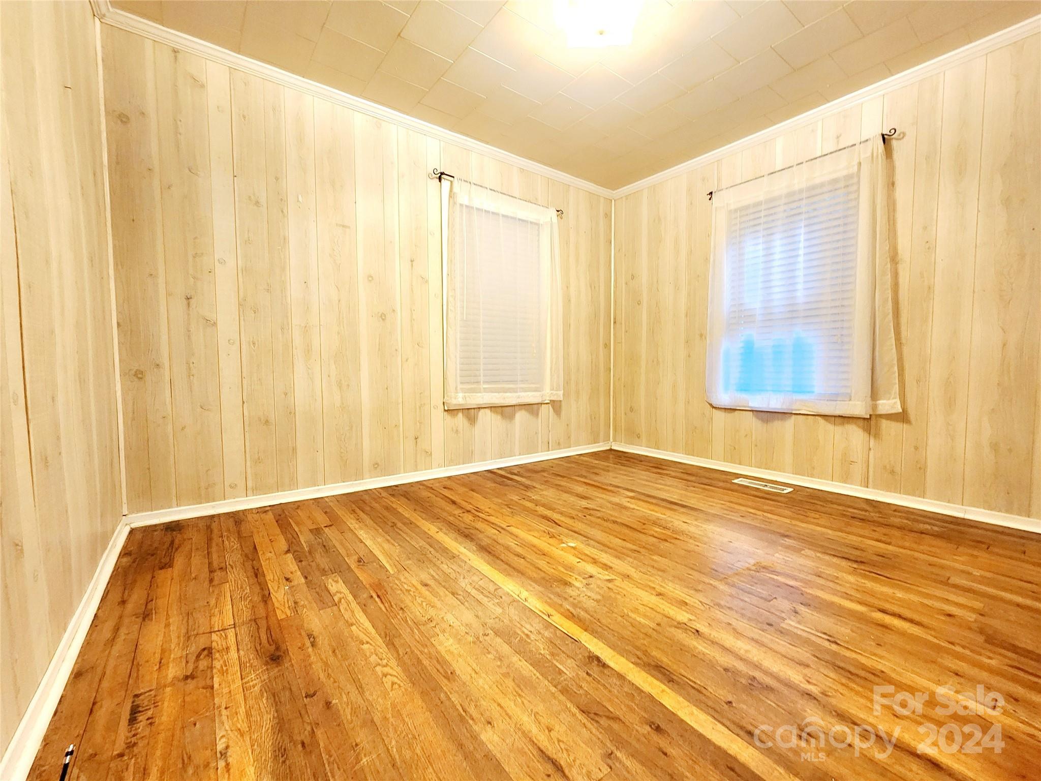 3004 Goble Road Hiddenite, NC 28636 - Photo 10 of 17 a view of an empty room with wooden floor and a window