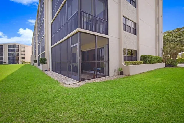 a view of an house with backyard and porch