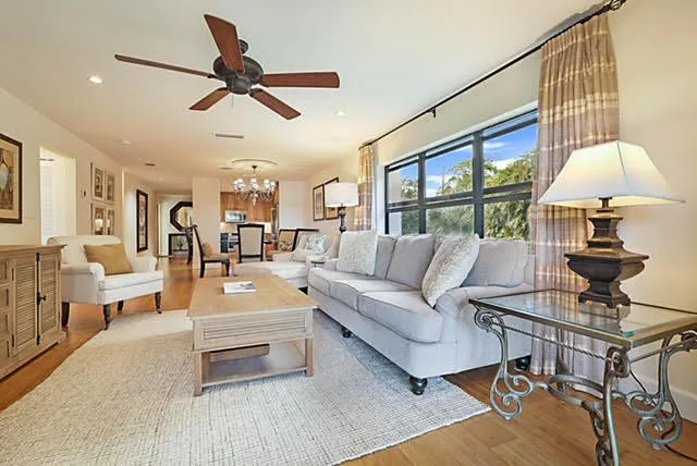 a living room with furniture or couch and a ceiling fan
