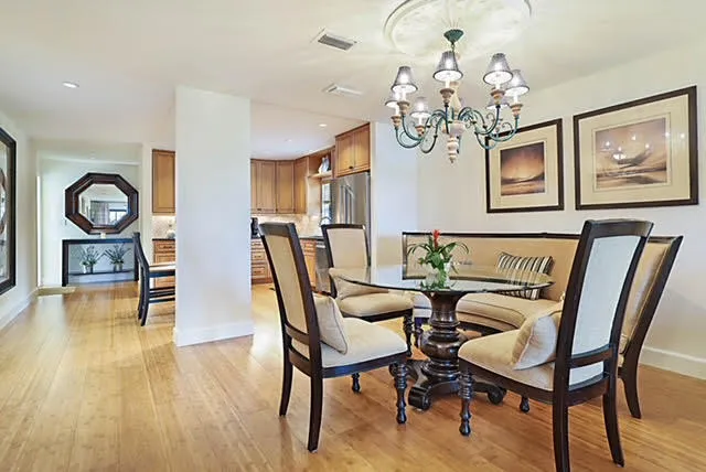 a view of a dining room with furniture wooden floor and chandelier