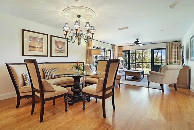 a view of a dining room with furniture a chandelier and wooden floor