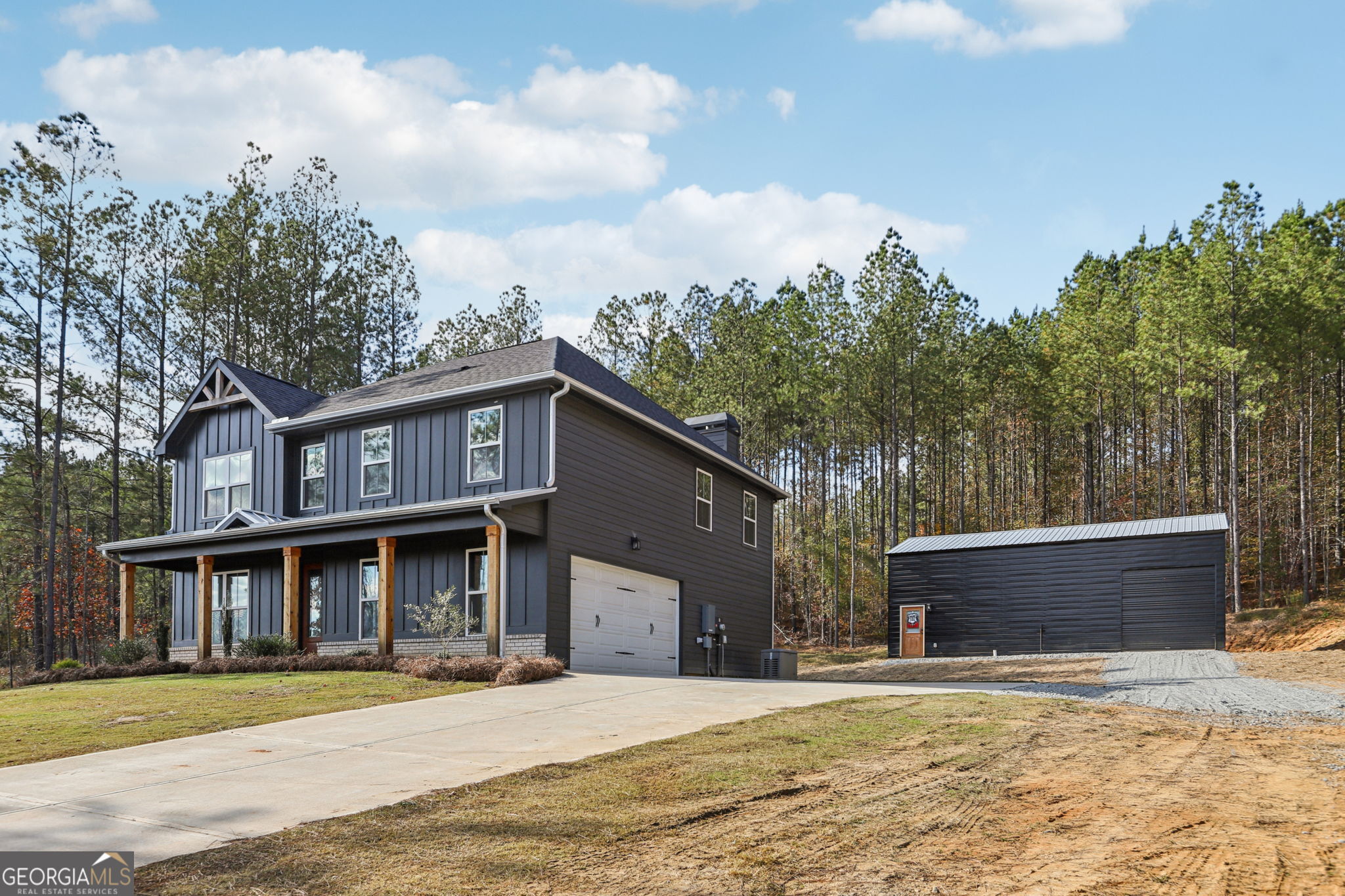 779 Millen Road Monticello, GA 31064 - Photo 11 of 52 a front view of a house with a yard and garage