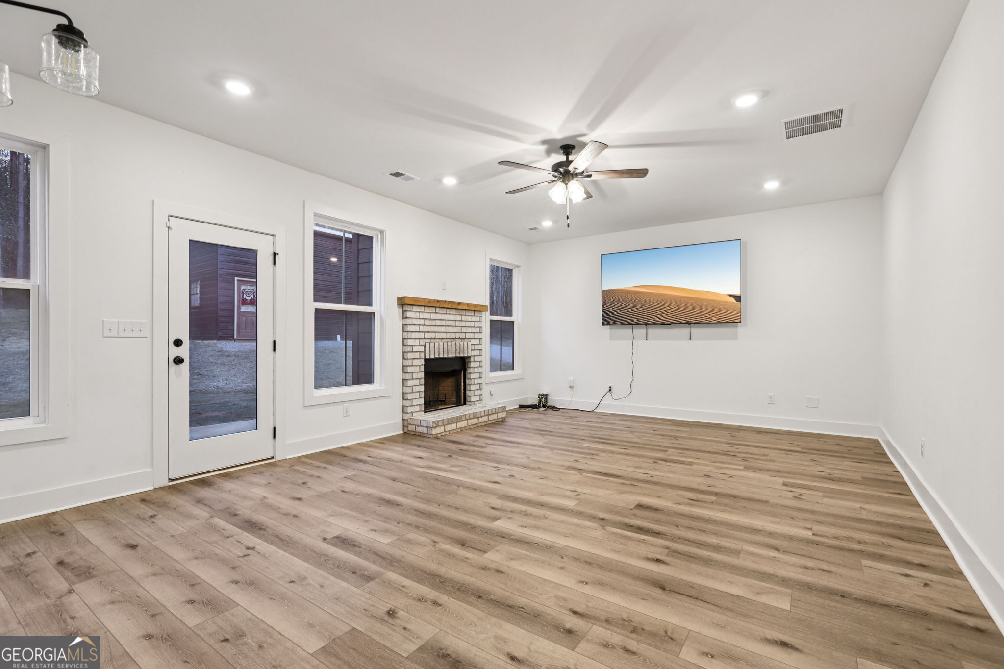 779 Millen Road Monticello, GA 31064 - Photo 12 of 52 a view of empty room with fireplace and fan