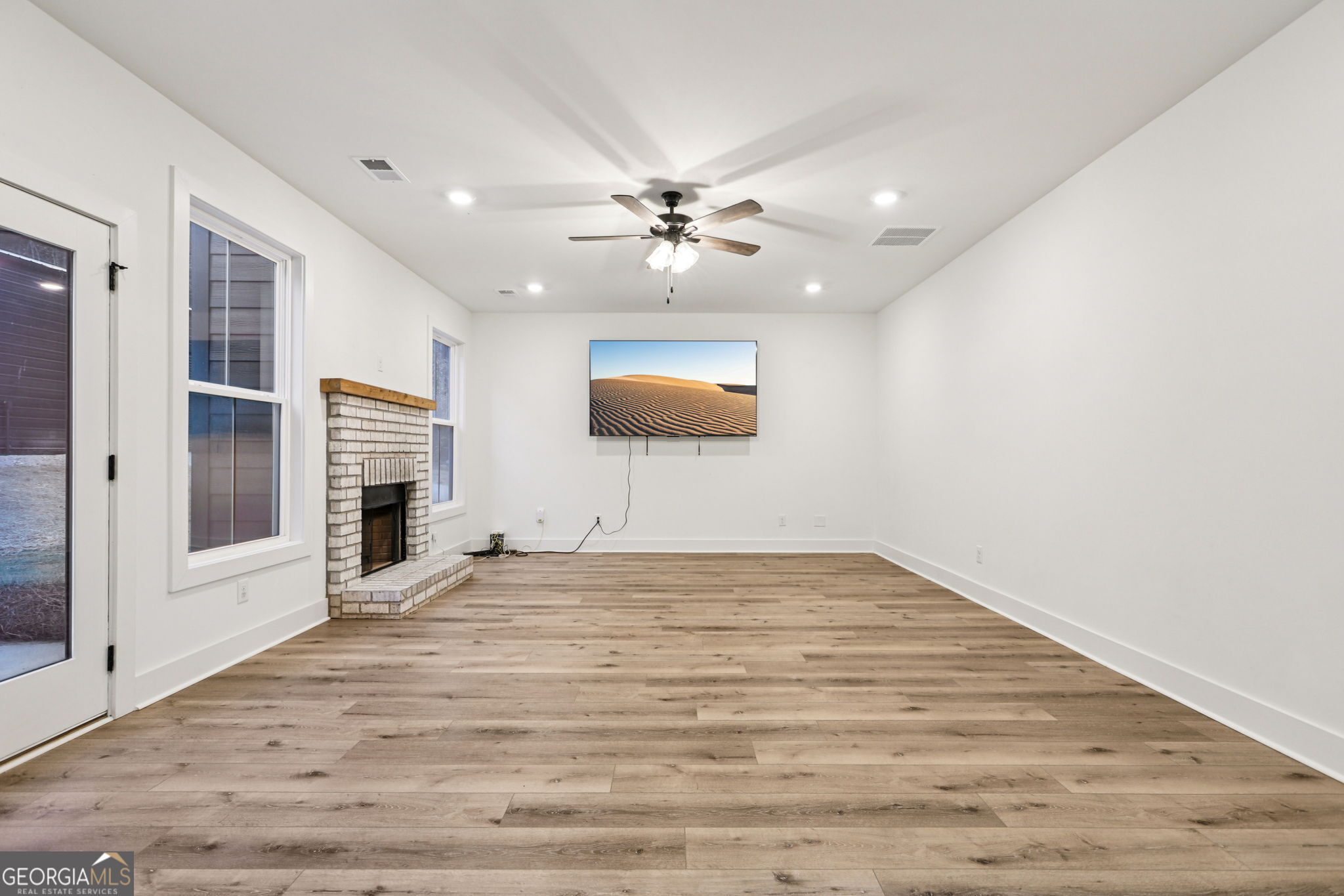 779 Millen Road Monticello, GA 31064 - Photo 13 of 52 an empty room with windows and ceiling fan