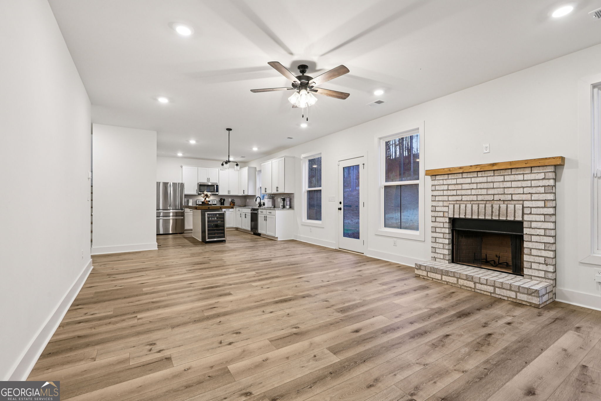 779 Millen Road Monticello, GA 31064 - Photo 14 of 52 a view of an empty room with a fireplace and a window