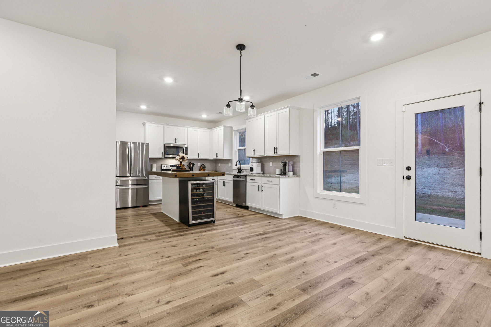 779 Millen Road Monticello, GA 31064 - Photo 15 of 52 a kitchen with stainless steel appliances kitchen island granite countertop a stove and a refrigerator