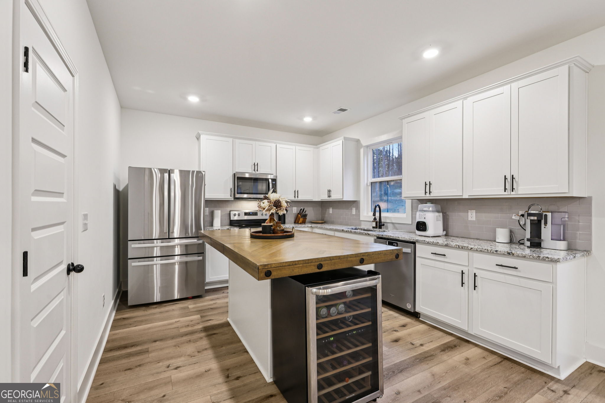 779 Millen Road Monticello, GA 31064 - Photo 19 of 52 a kitchen with kitchen island granite countertop a sink stove and refrigerator