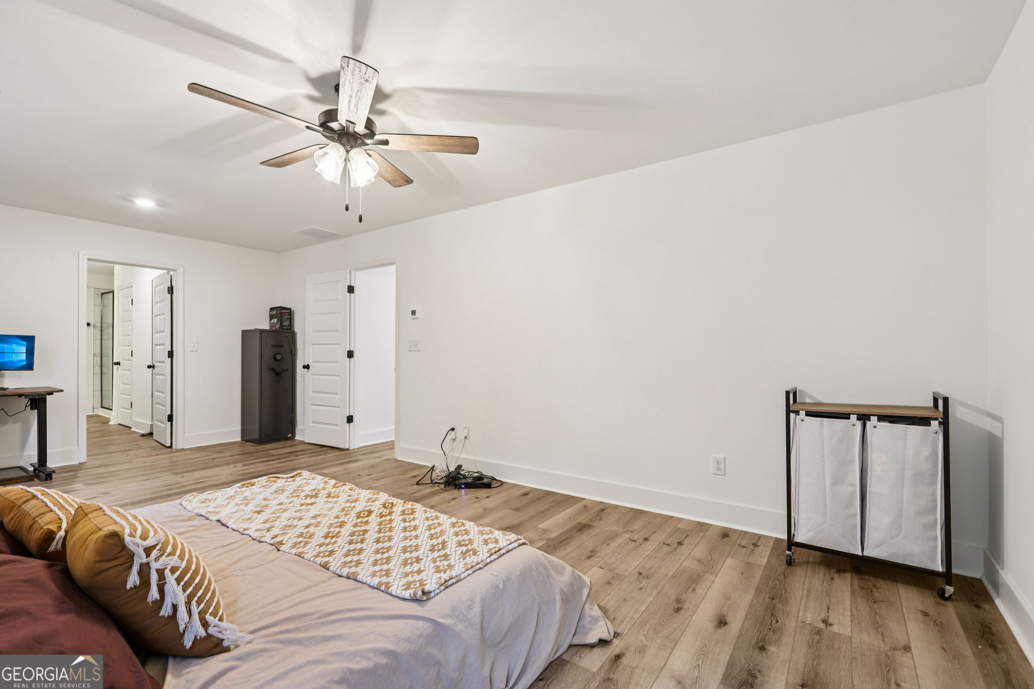779 Millen Road Monticello, GA 31064 - Photo 25 of 52 a bedroom with a large bed and a chandelier