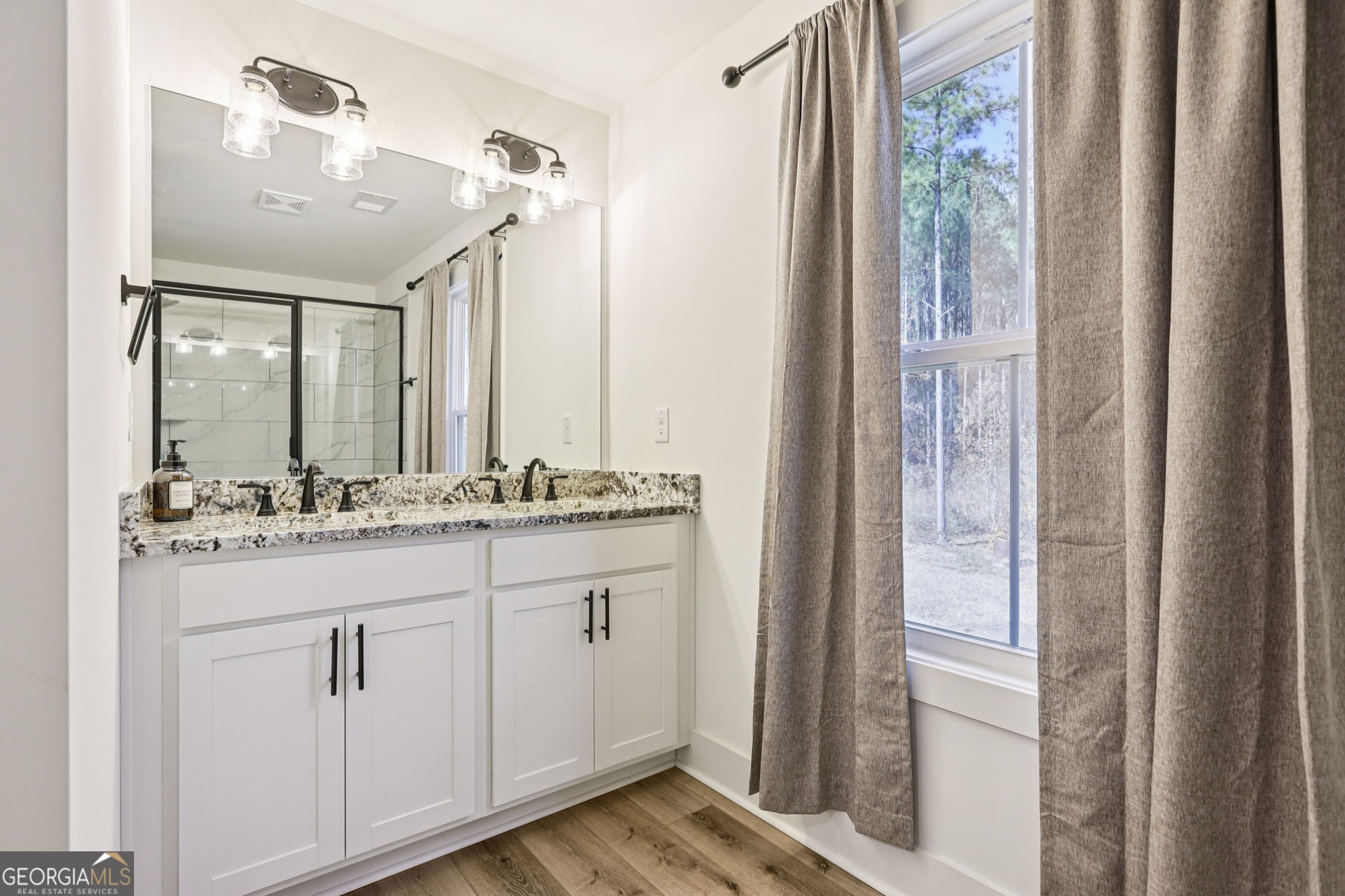 779 Millen Road Monticello, GA 31064 - Photo 26 of 52 a bathroom with a sink and a mirror
