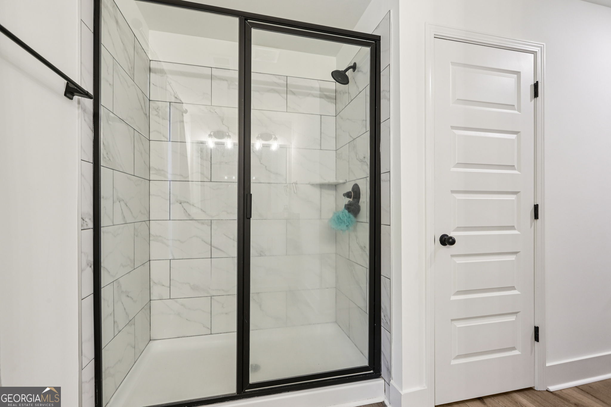 779 Millen Road Monticello, GA 31064 - Photo 27 of 52 a bathroom with a glass shower door