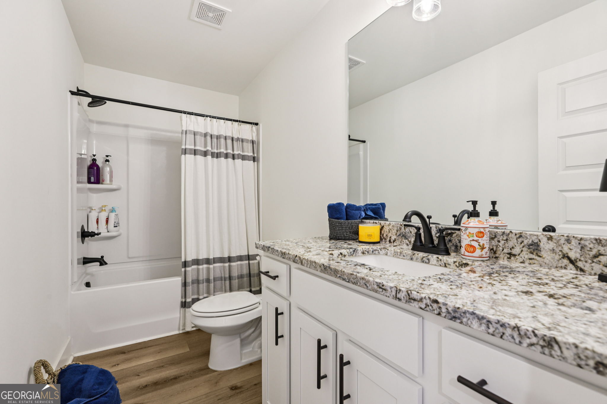779 Millen Road Monticello, GA 31064 - Photo 30 of 52 a bathroom with a granite countertop sink toilet and shower