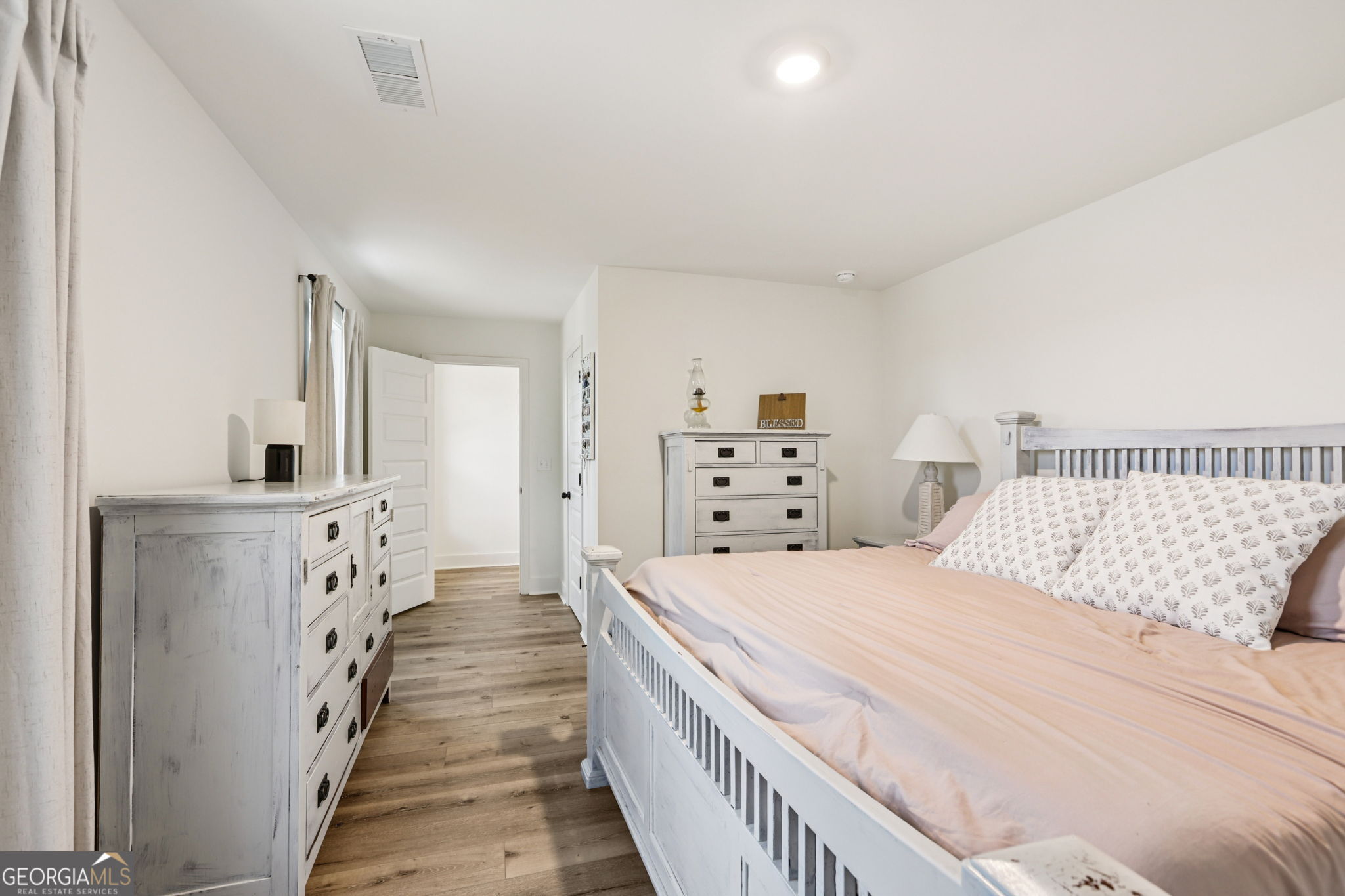 779 Millen Road Monticello, GA 31064 - Photo 33 of 52 a spacious bedroom with a bed and a walk in closet