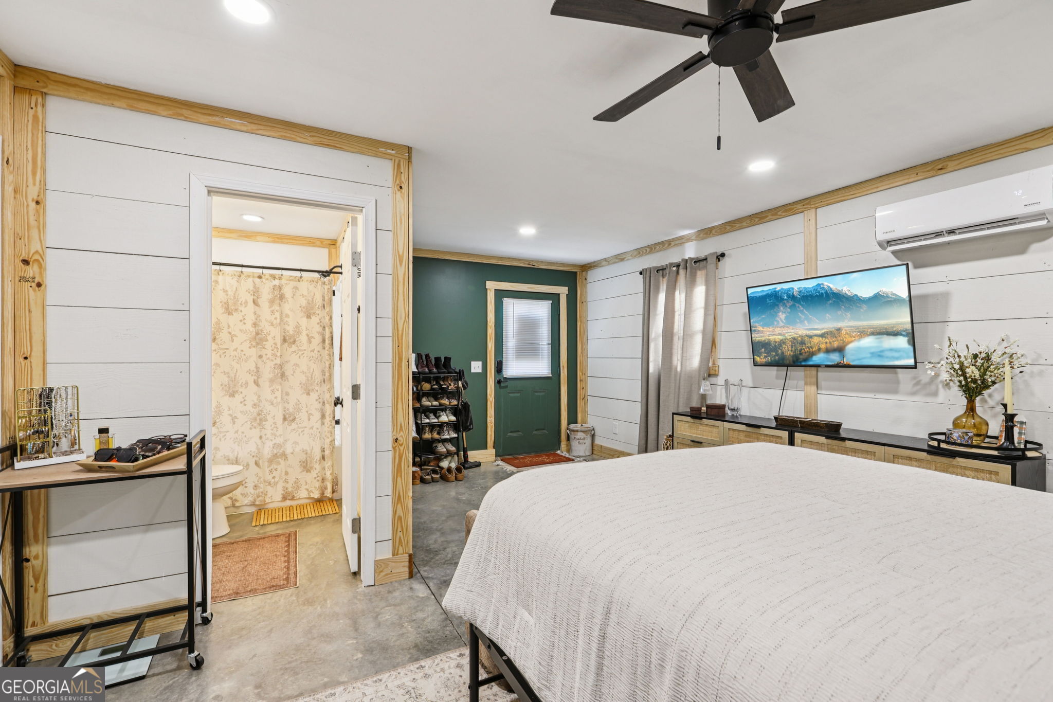 779 Millen Road Monticello, GA 31064 - Photo 41 of 52 a bedroom with a bed and a flat tv screen on dresser