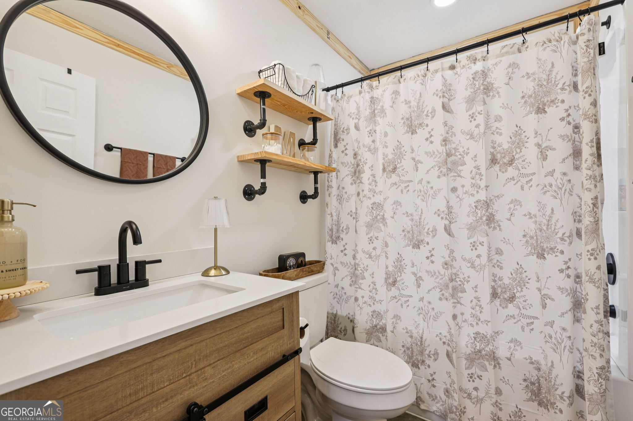 779 Millen Road Monticello, GA 31064 - Photo 42 of 52 a bathroom with a toilet a sink and a mirror
