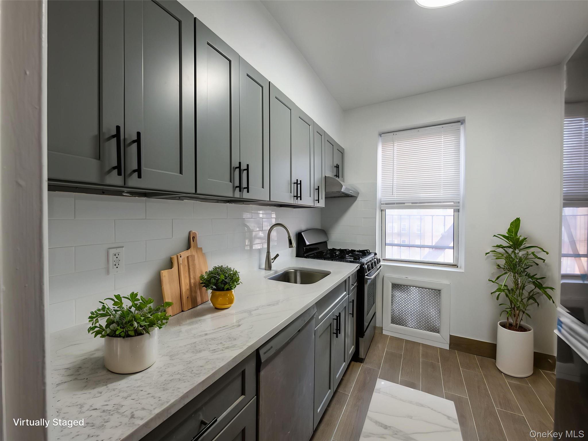 63-60 102nd Street, Unit D11 Queens, NY 11374 - Photo 11 of 21 a kitchen with a potted plant on the counter and cabinets