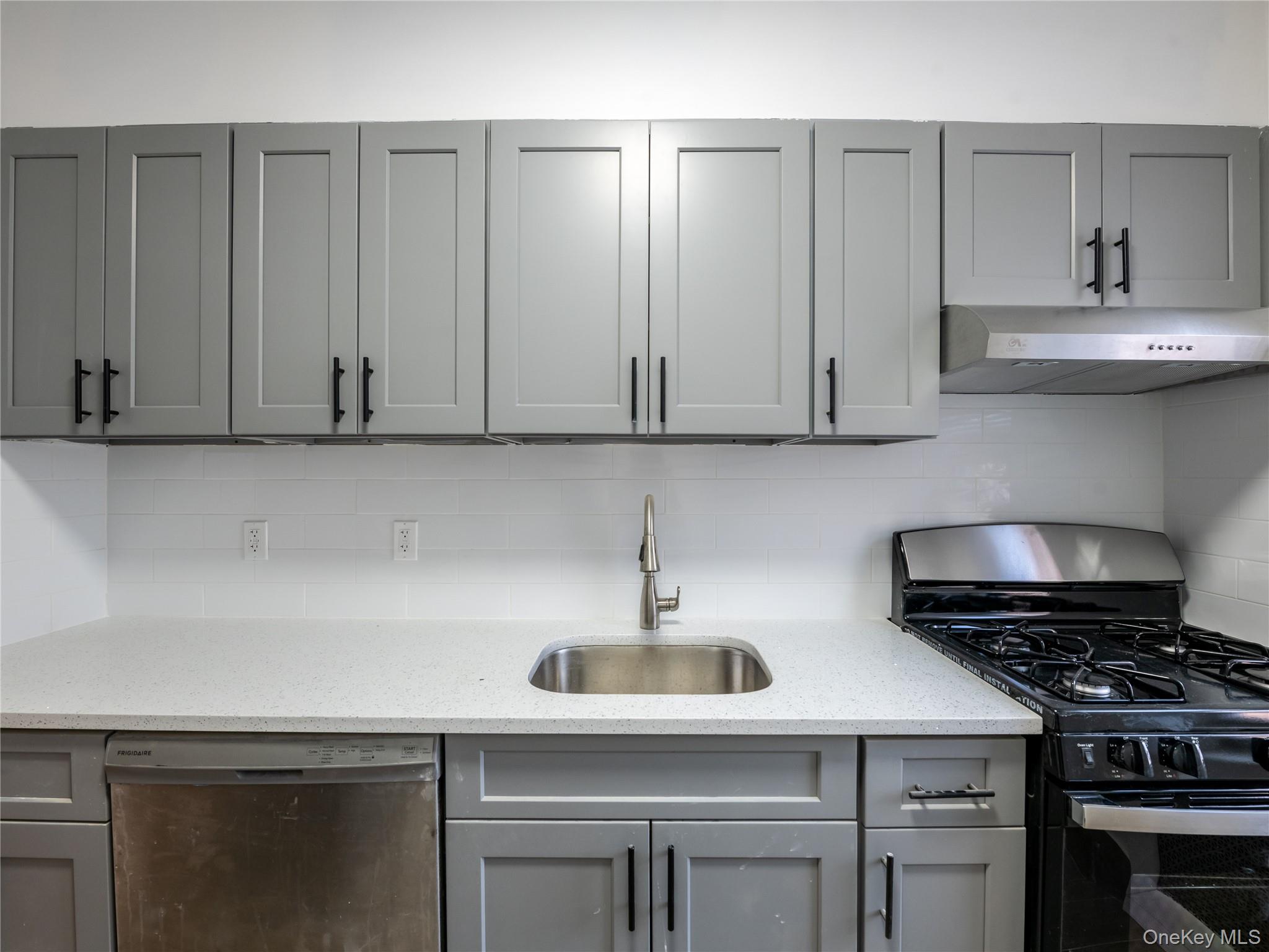 63-60 102nd Street, Unit D11 Queens, NY 11374 - Photo 12 of 21 a kitchen with stainless steel appliances a sink a stove and cabinets