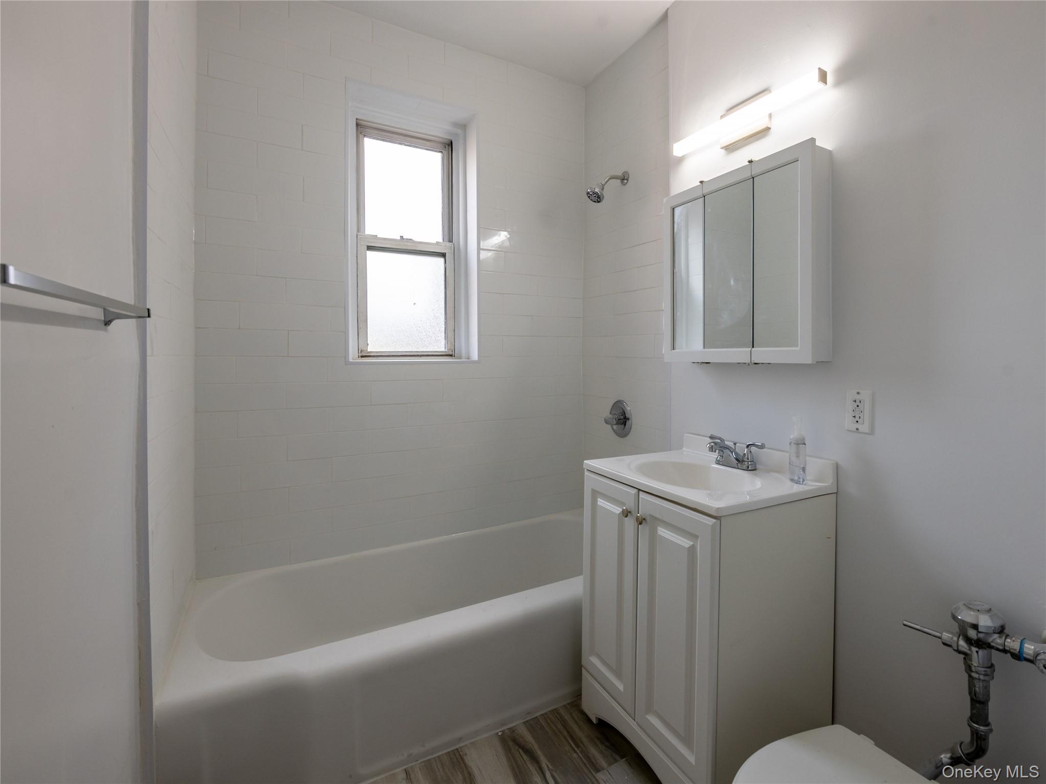 63-60 102nd Street, Unit D11 Queens, NY 11374 - Photo 18 of 21 a bathroom with a sink a toilet and shower
