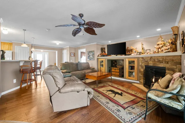 a kitchen with stainless steel appliances granite countertop a sink dishwasher and cabinets with wooden floor