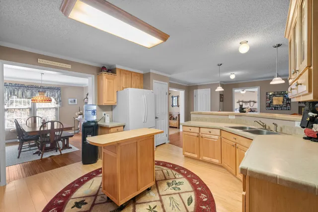a bedroom with a bed a chandelier and a window