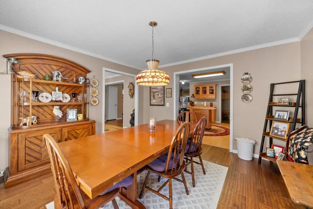 a bedroom with a bed a flat screen tv and a chandelier