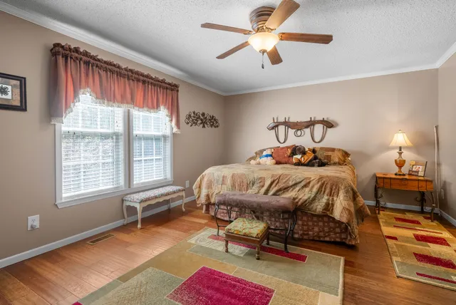 a bathroom with a granite countertop sink a mirror and shower