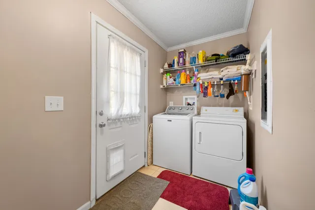 an aerial view of a house with a yard and lake view
