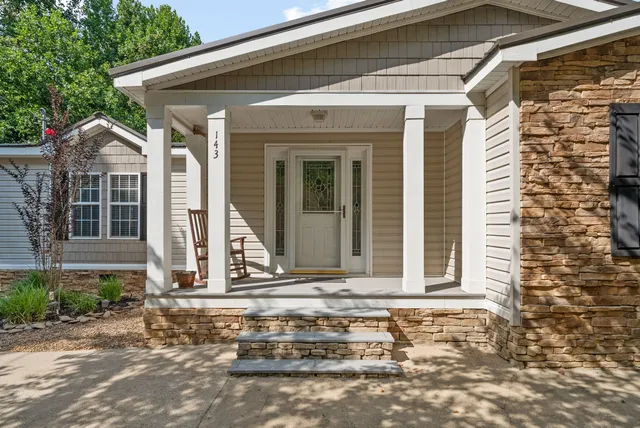 a living room with furniture ceiling fan and a rug