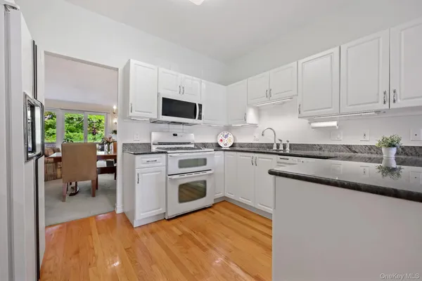 a kitchen with a stove a sink and a microwave