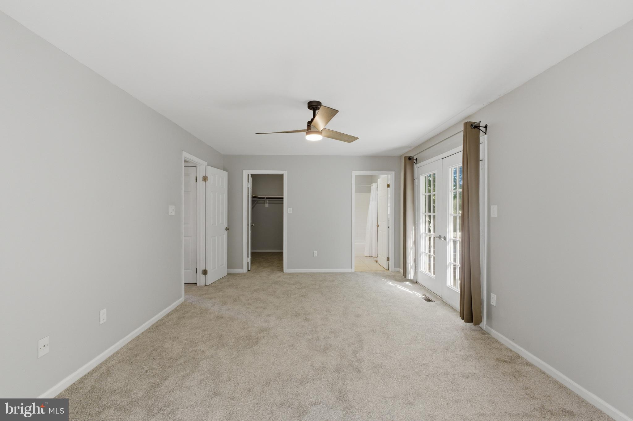 13601 Pendleton Street Fort Washington, MD 20744 - Photo 21 of 50 a view of a big room with wooden floor and a ceiling fan