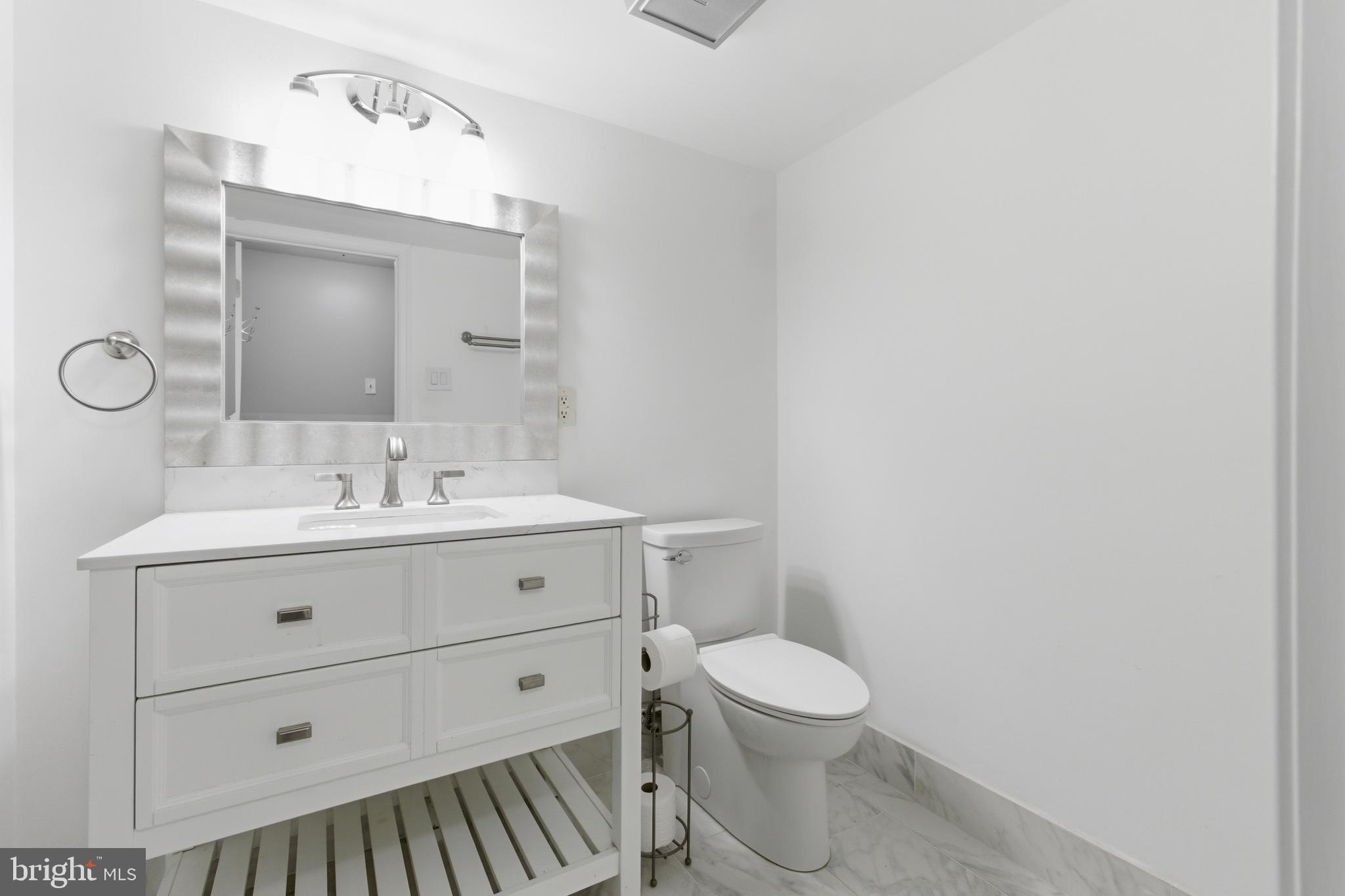13601 Pendleton Street Fort Washington, MD 20744 - Photo 32 of 50 a bathroom with a toilet a sink and mirror