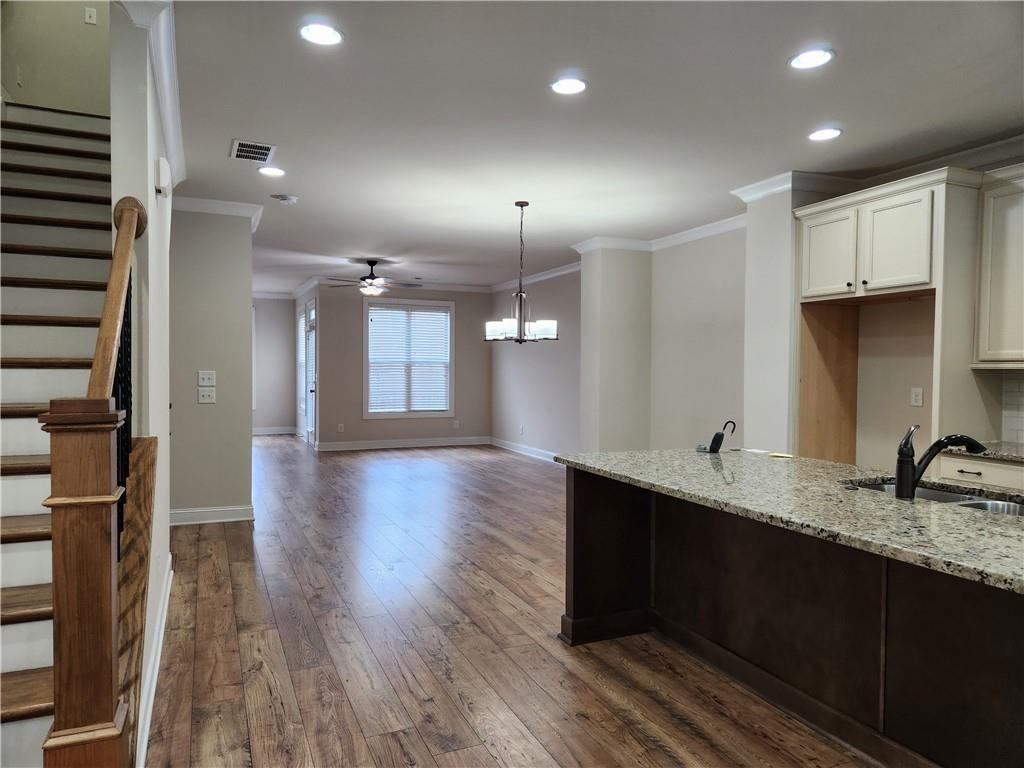 1323 Faircrest Way Suwanee, GA 30024 - Photo 6 of 16 a kitchen with stainless steel appliances granite countertop a sink a stove and a wooden floors
