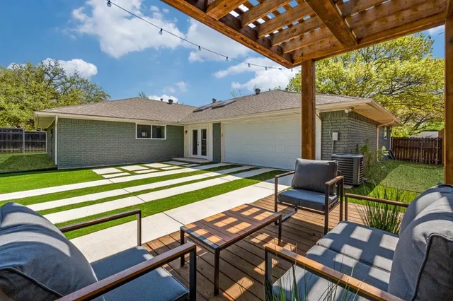 a view of swimming pool with a table and chairs under an umbrella