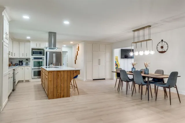 a view of kitchen with cabinets table and chairs