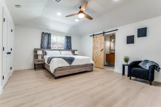 a spacious bedroom with a bed and a couch