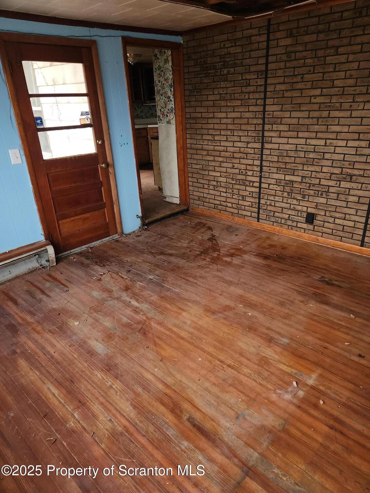 819 Brook Street Scranton, PA 18505 - Photo 13 of 26 a view of an empty room with wooden floor and a window