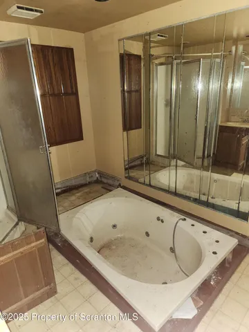 a bathroom with a tub and a sink