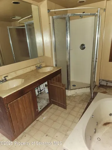 a bathroom with a tub sink and mirror