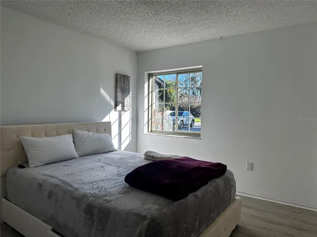 a bedroom with a bed window and wall painting