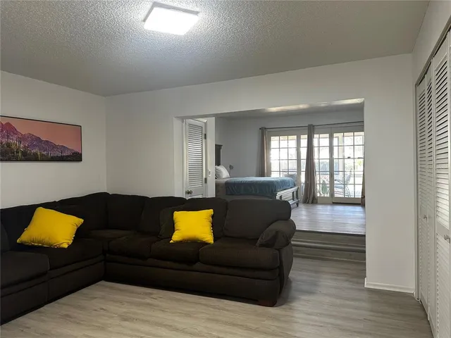 a living room with furniture and a lamp