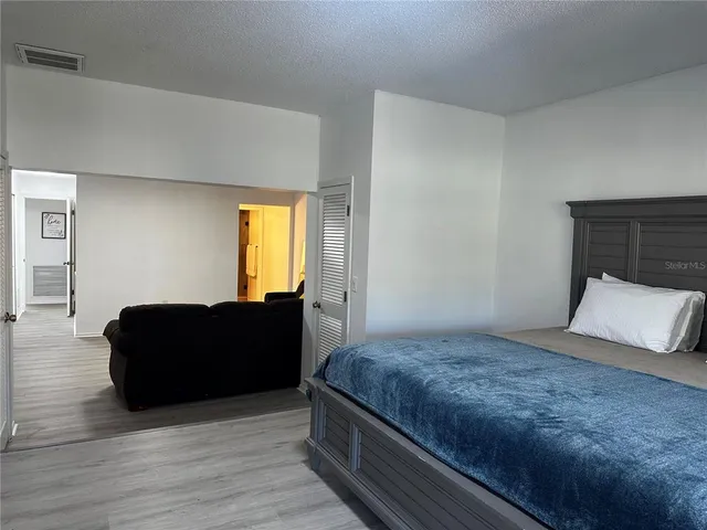 a bedroom with a bed and window